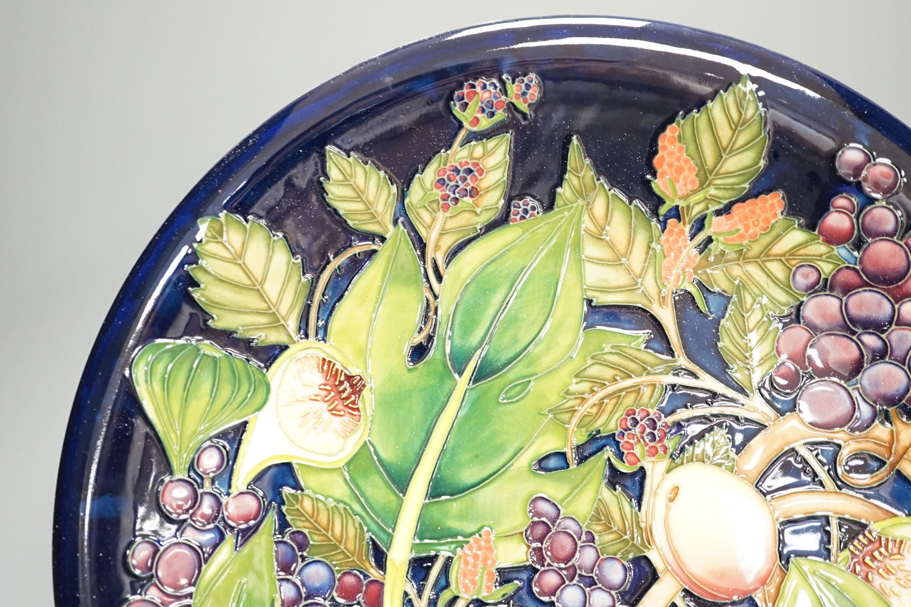 A Moorcroft Queen’s Choice pattern wall charger, dated 2003, signed by Emma Bossons, 36cm., in original box